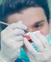 A dental technician working on a denture