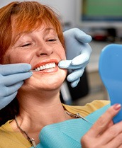 A smiling senior woman enjoying her new dentures