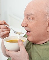 Man eating a bowl of soup