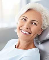 Woman smiling with her new dental implants