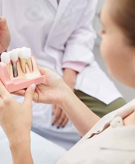 dentist explaining dental implants to patient 