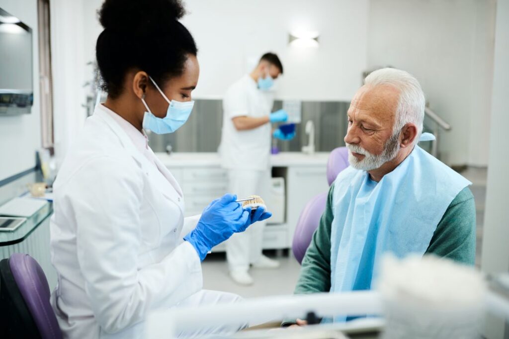 A man at a denture evaluation with his dentist.